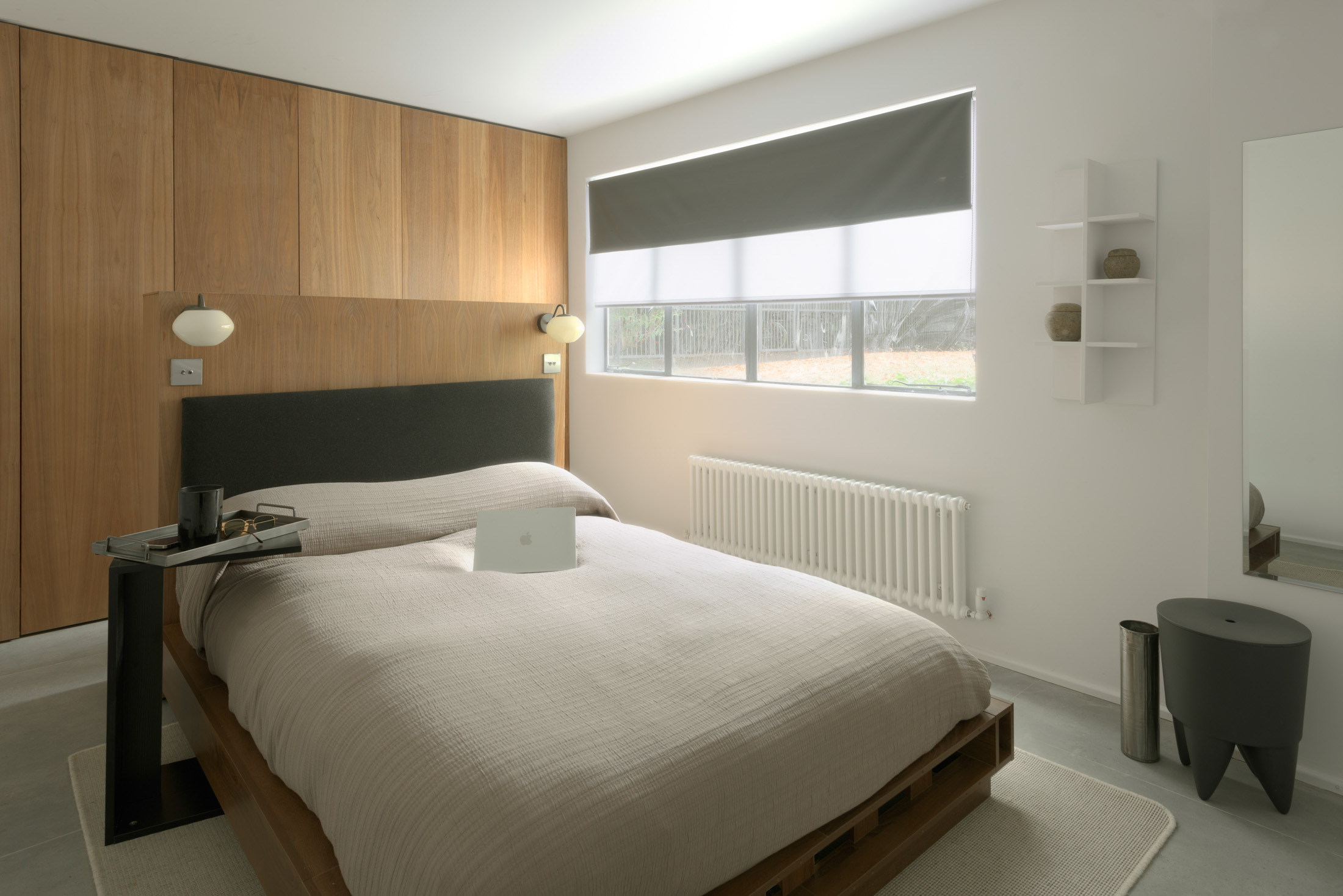 Main bedroom with walnut joinery and a double bed